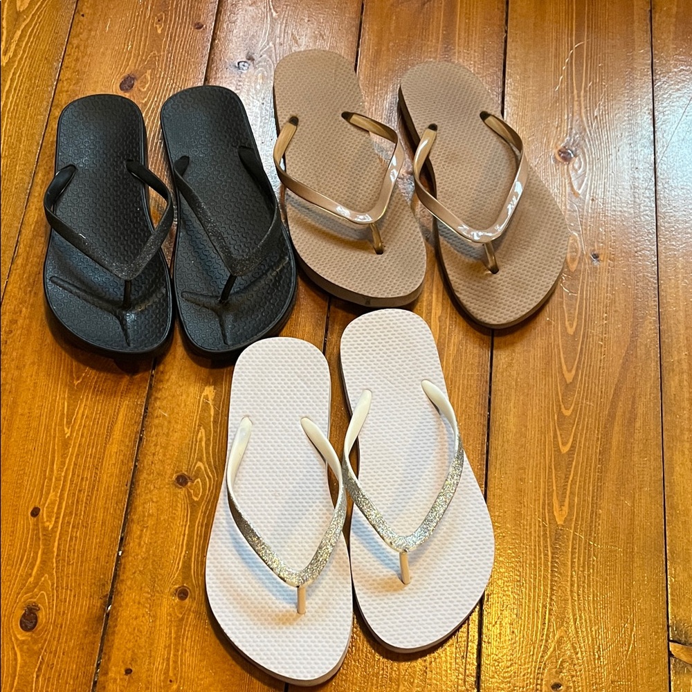 Set of Three Flip Flops in Black, Brown, and White